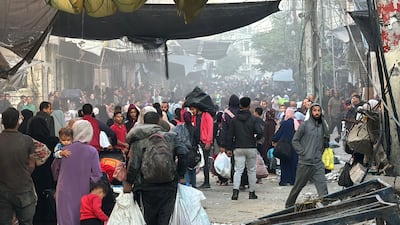 Palestinians walk down a street in Beit Lahia. Hundreds of thousands of people in northern Gaza remain under siege. AFP
